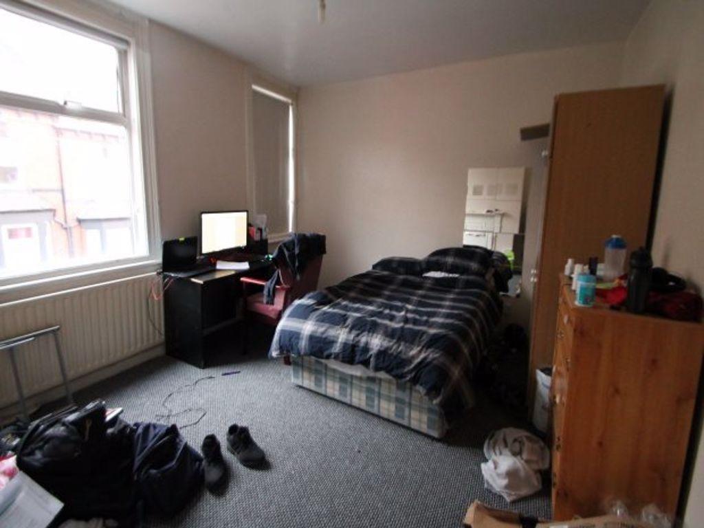 A cozy bedroom featuring a double bed with a pl...