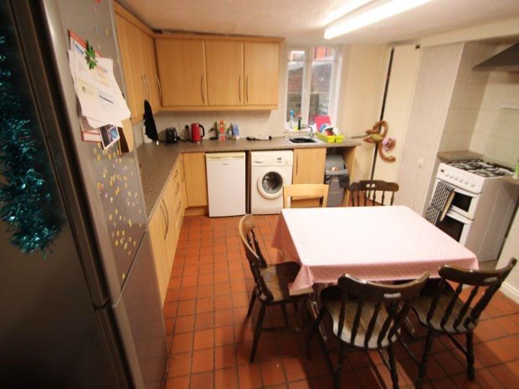 A well-lit kitchen area featuring wooden units,...