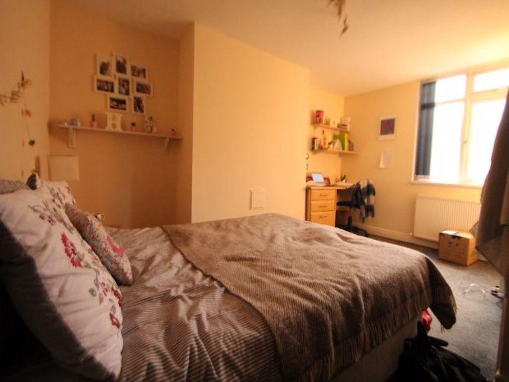 A spacious and inviting master bedroom featurin...