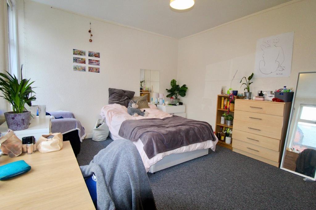 A spacious and well-organized master bedroom fe...