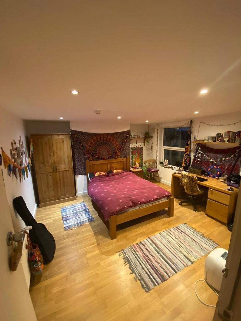 Bright, well-decorated double bedroom with wood...