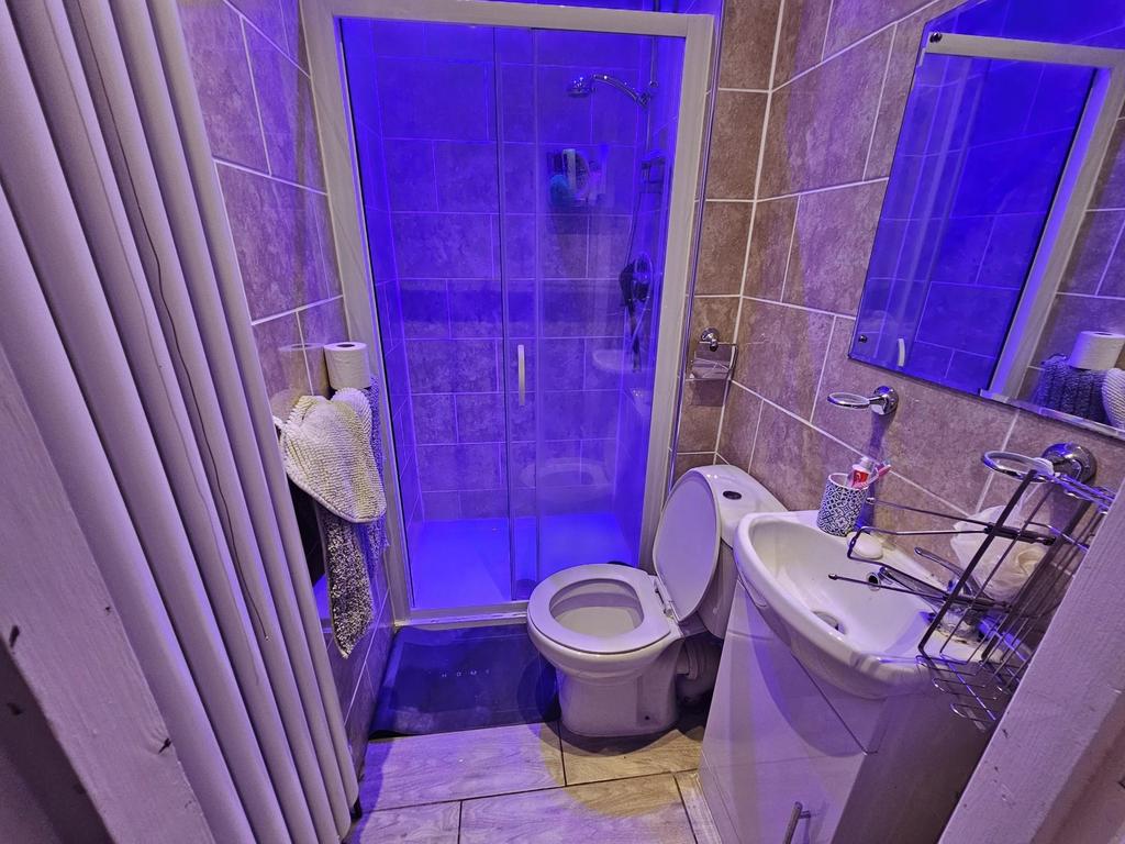 A well-maintained bathroom with a toilet, sink,...