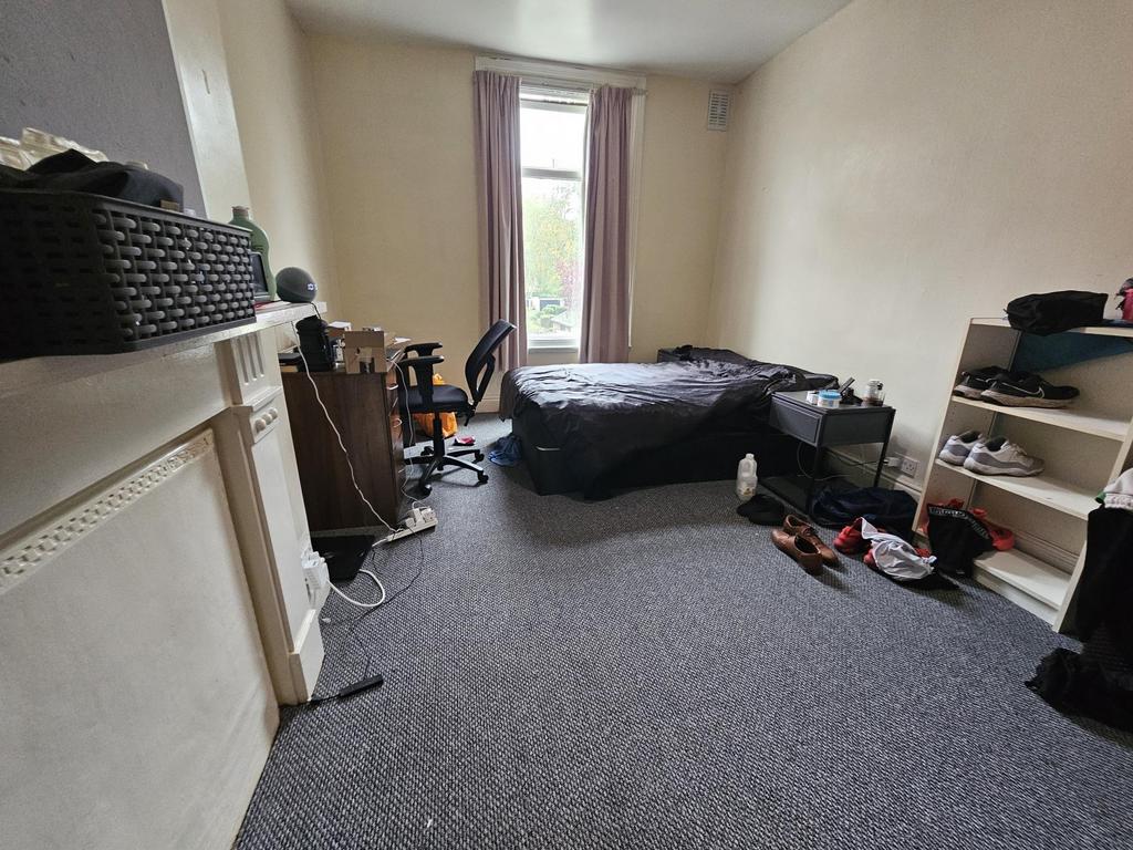 A modest living room with a large window provid...