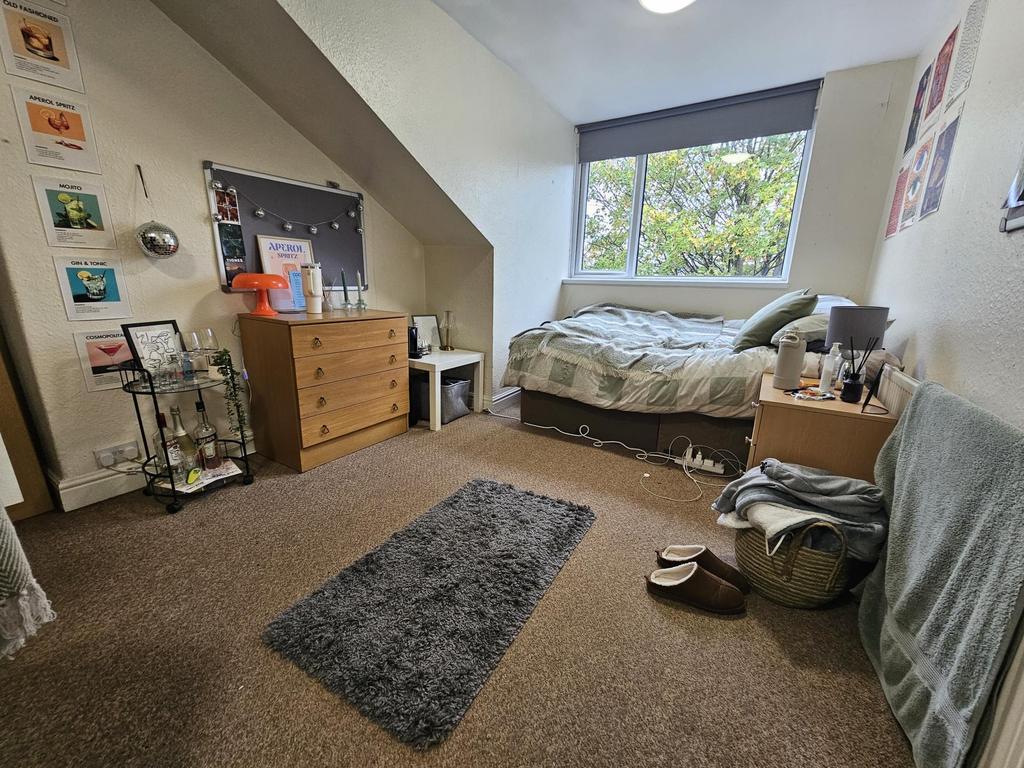 Bright and welcoming bedroom with a comfortable...