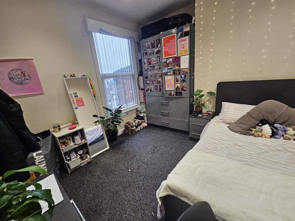 Bright and cozy bedroom with a comfortable bed,...