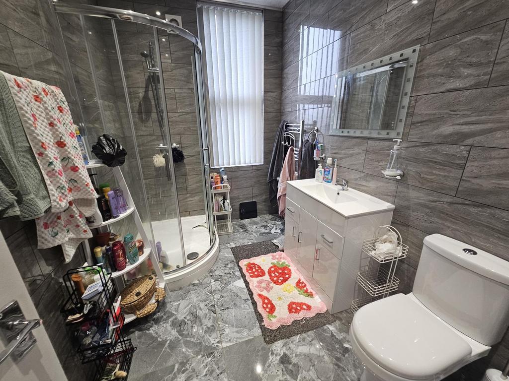 A modern bathroom featuring a large shower encl...