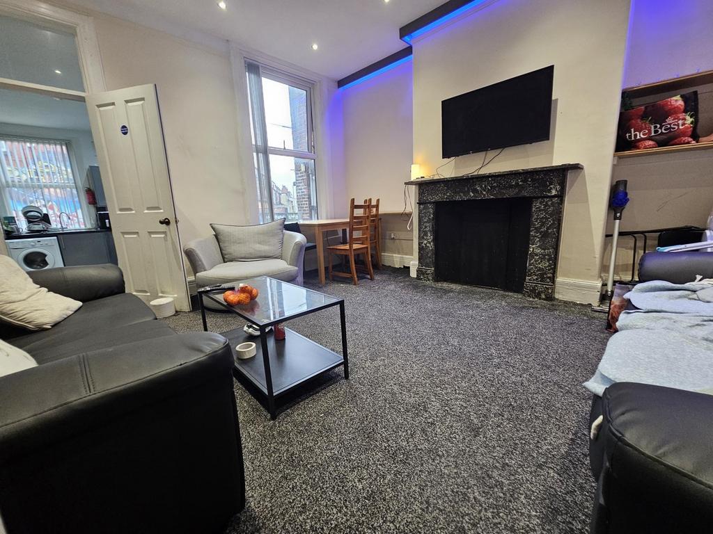 A spacious and modern living room featuring com...