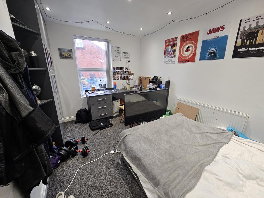 A cozy and well-maintained bedroom featuring a ...