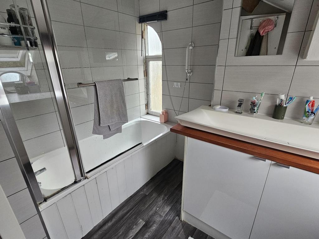 A clean and modern bathroom featuring a large b...