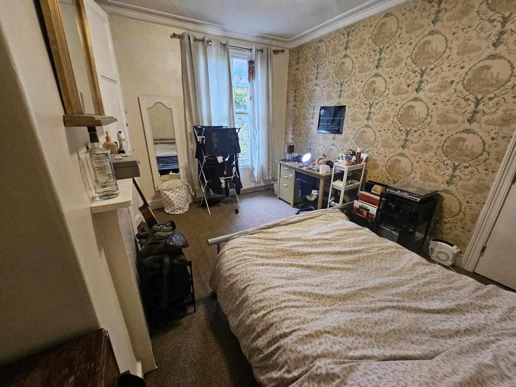 A cozy bedroom featuring a double bed with a he...