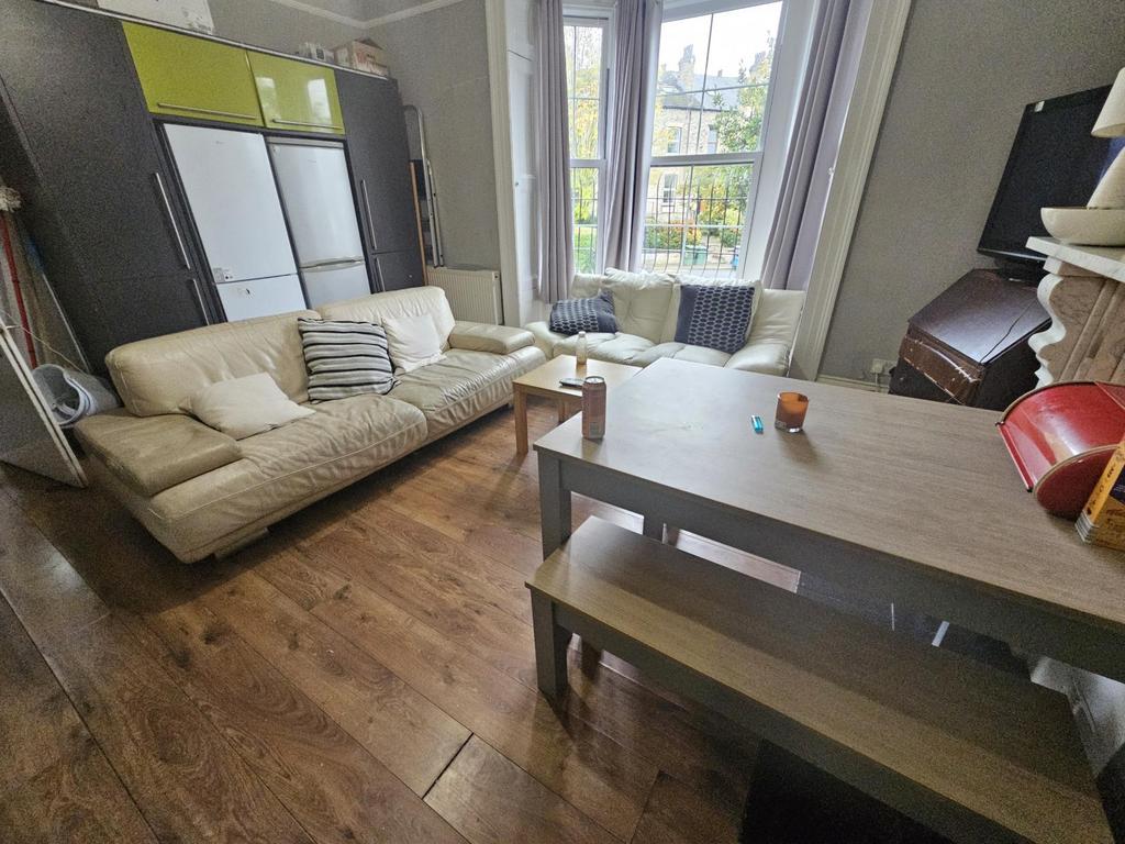 A bright and welcoming living room featuring a ...