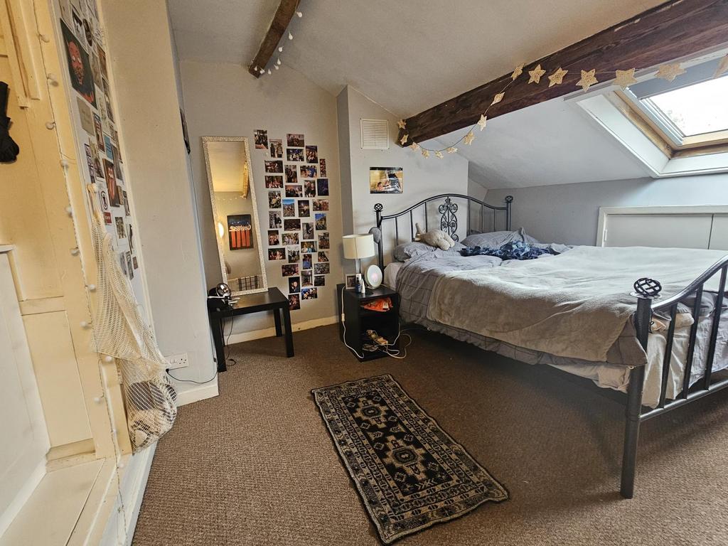 A spacious and well-lit master bedroom featurin...