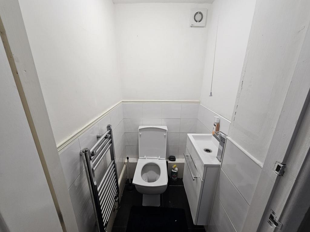 A well-maintained bathroom with a toilet, small...