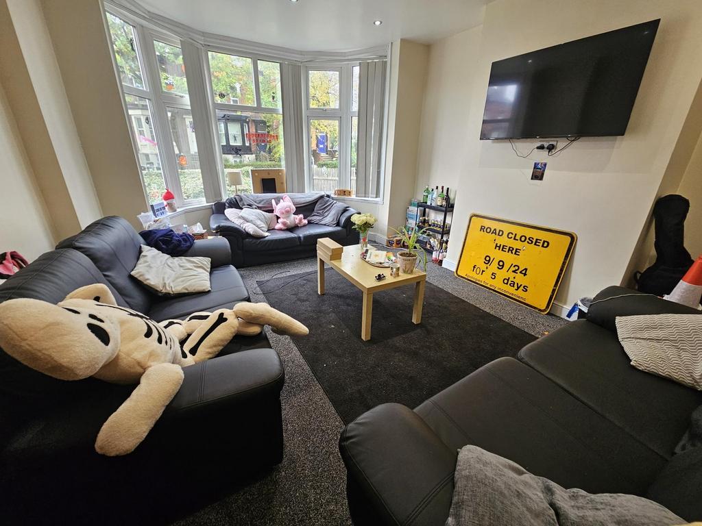 Bright and spacious living room featuring comfo...