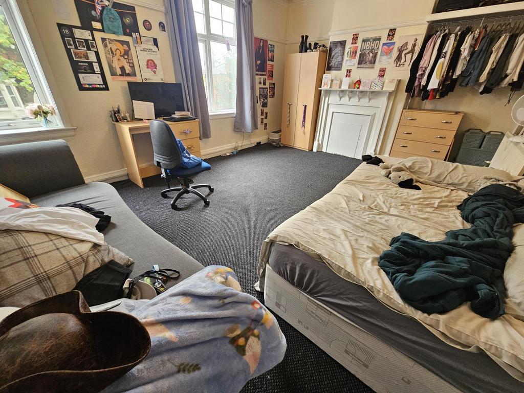 A cozy bedroom with a double bed, a window prov...