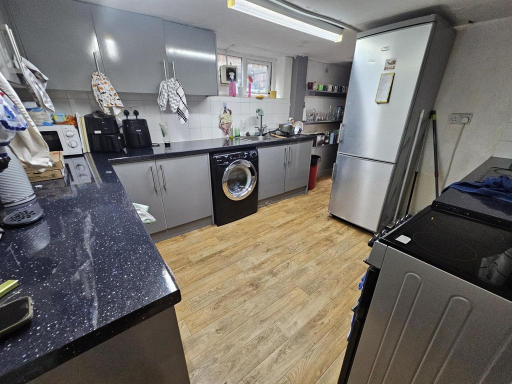 A modern kitchen featuring sleek cabinets, a re...