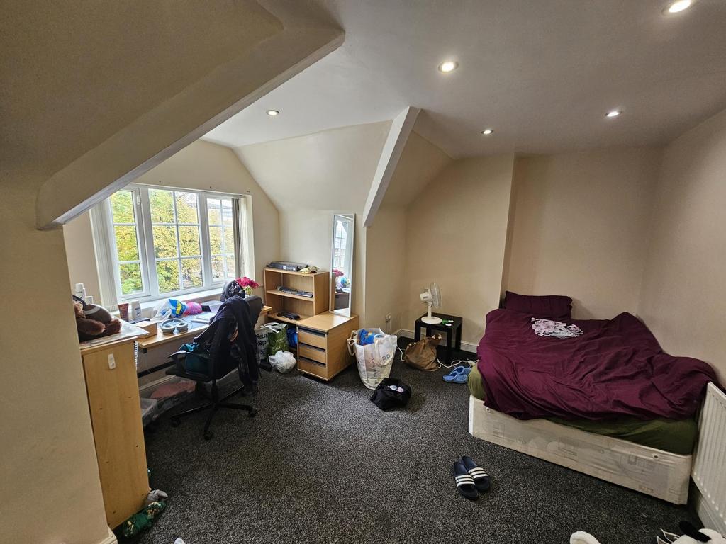 A comfortable, well-lit living room with large ...