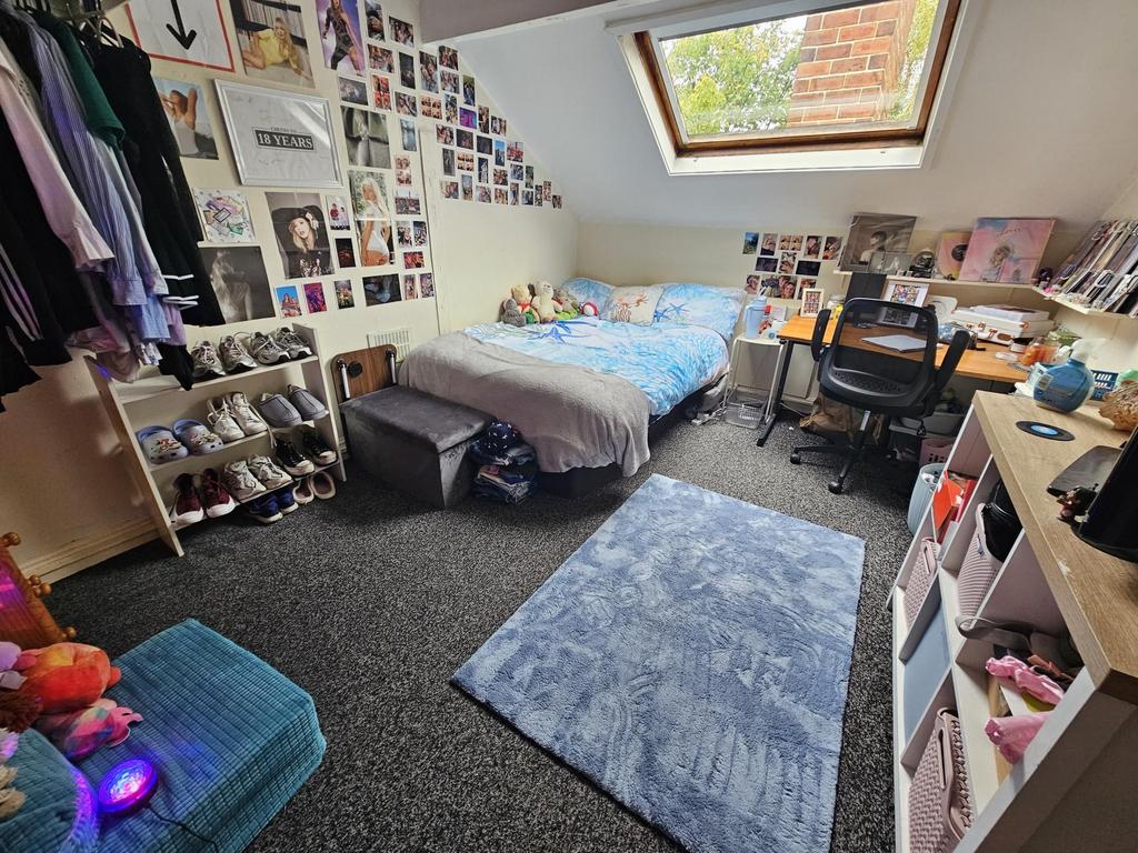 A spacious and inviting bedroom featuring a lar...