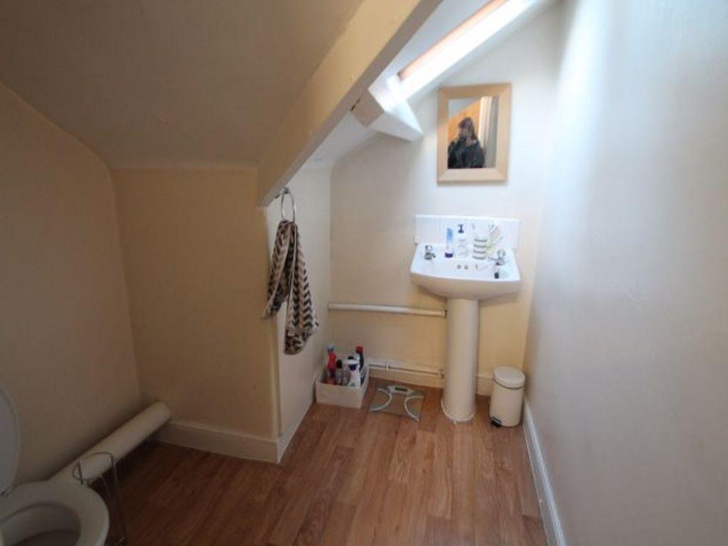 A clean and well-lit bathroom with a standard t...