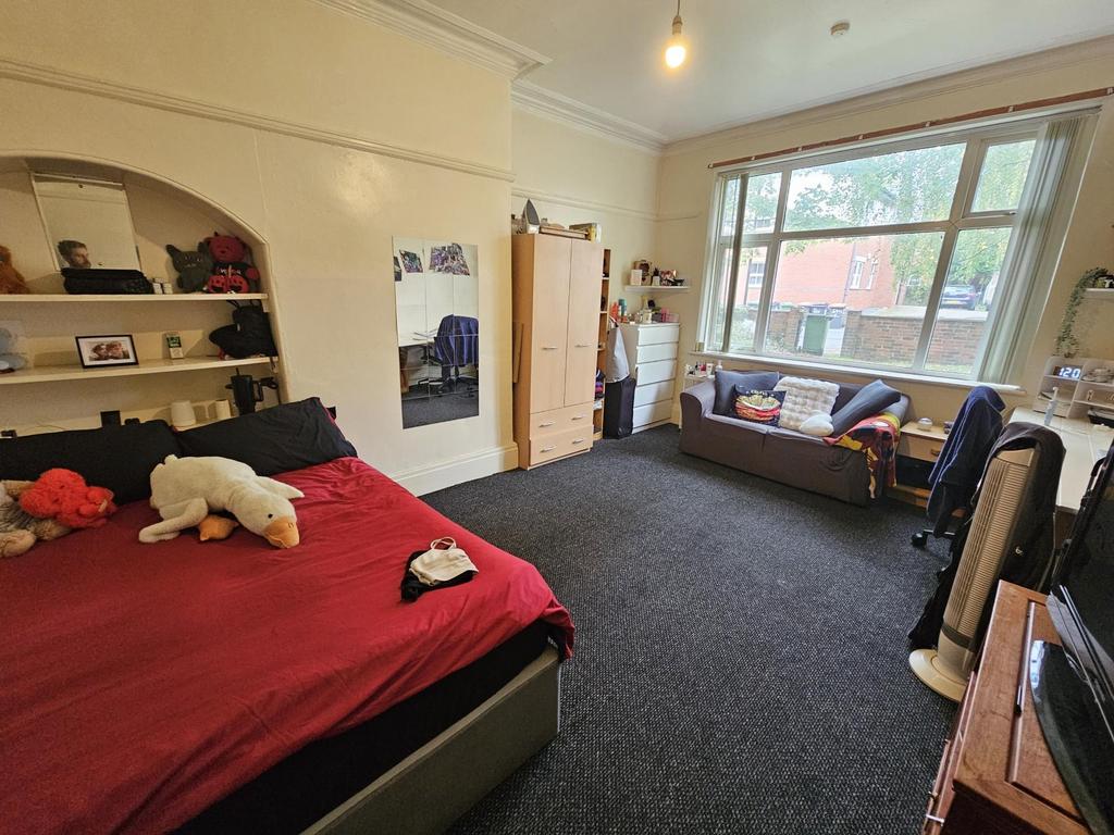 A comfortable double bedroom featuring a spacio...