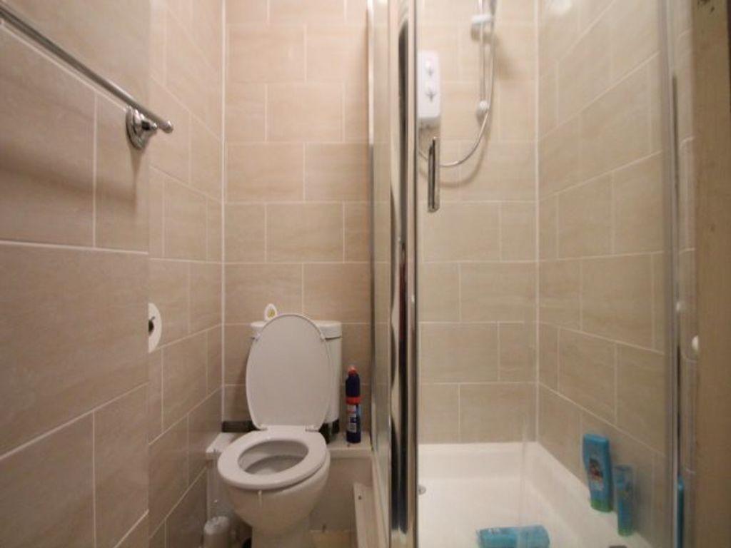 A modern, clean bathroom with a spacious shower...