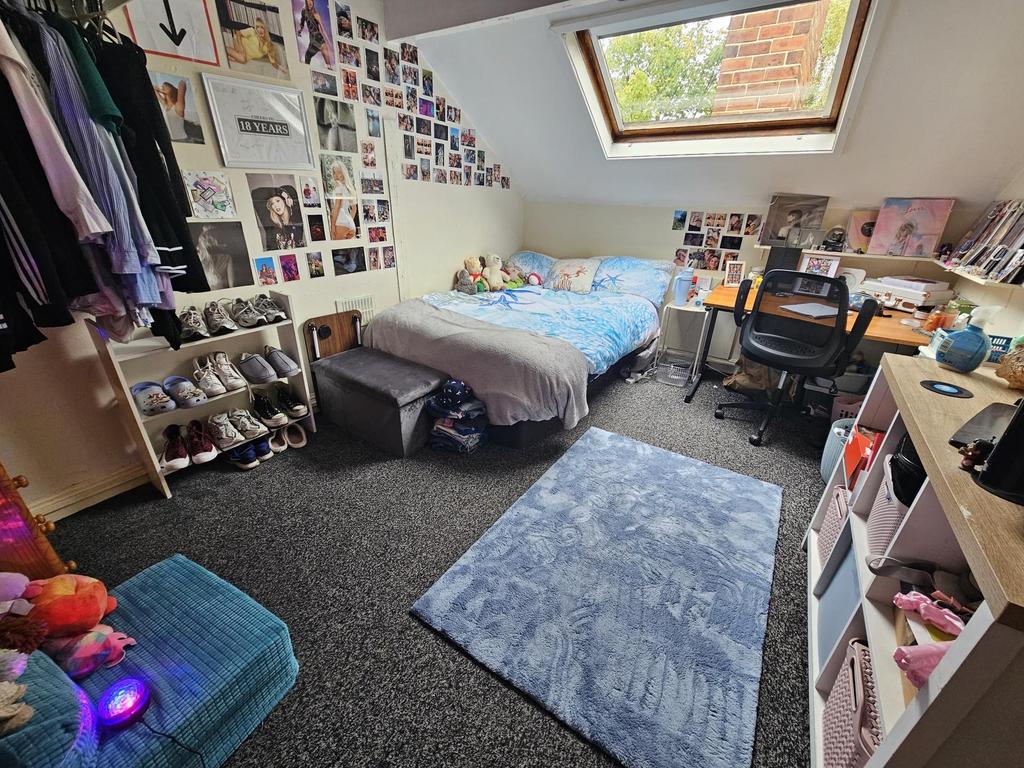 A bright and cozy bedroom featuring a comfortab...