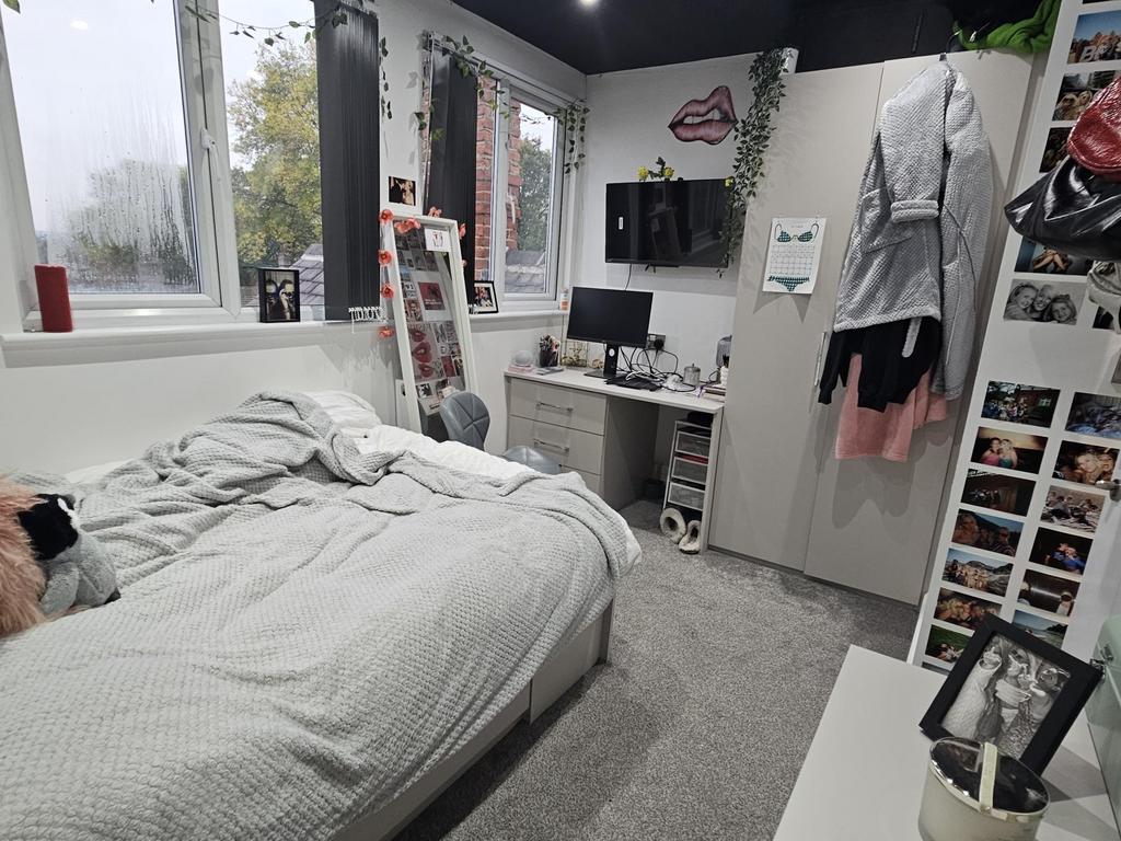 A cozy bedroom featuring a double bed, a large ...