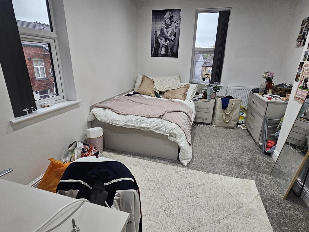 A cozy bedroom with a double bed positioned nea...