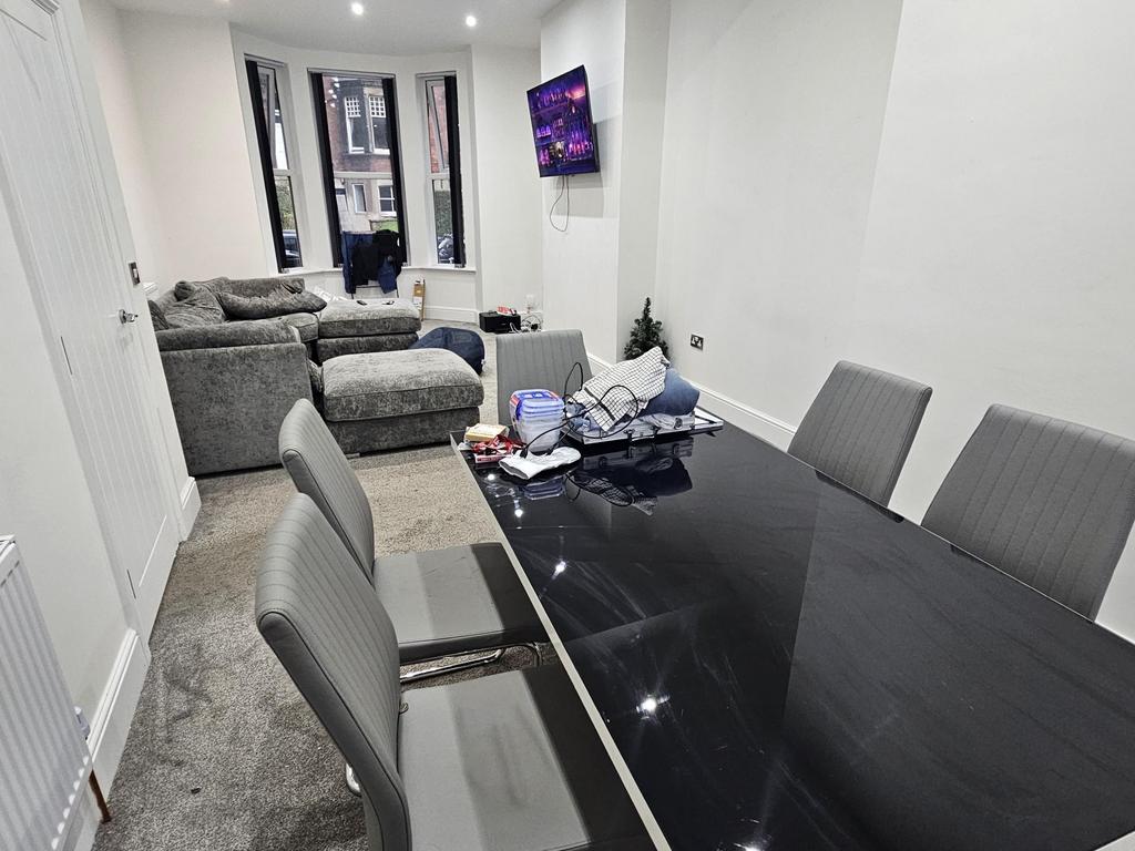 A modern, well-lit living room featuring comfor...