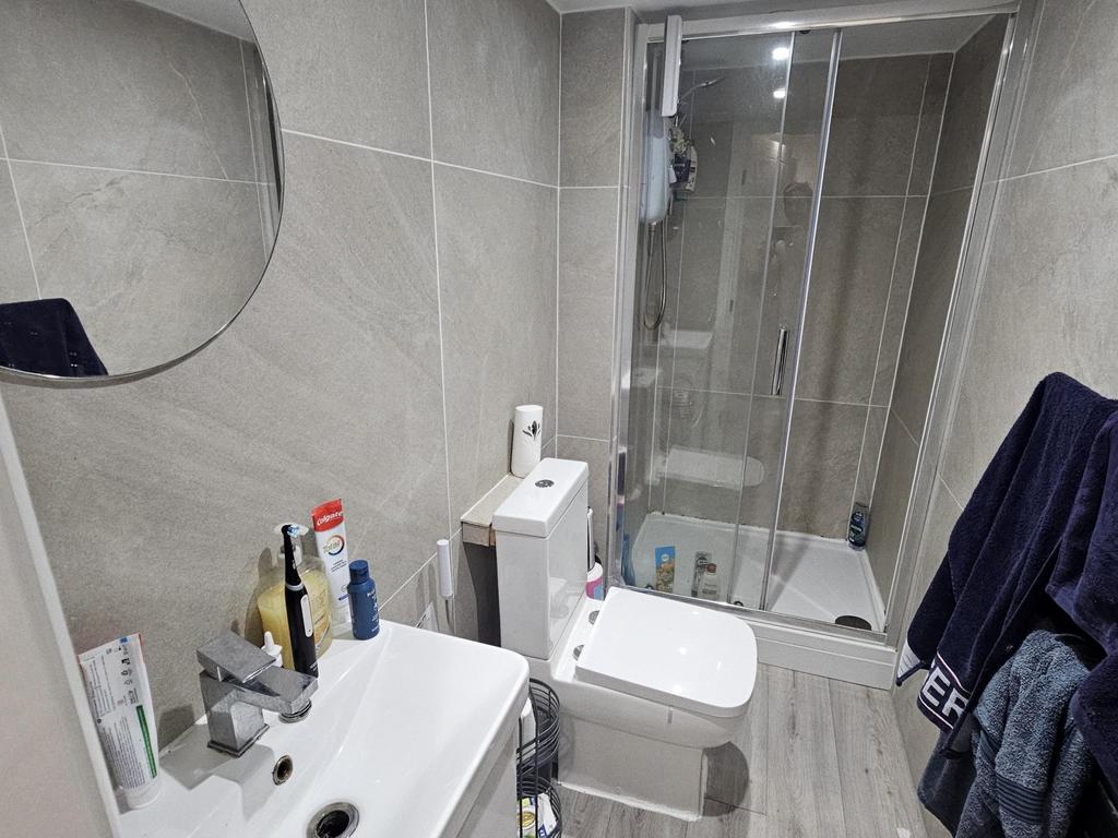 A clean and modern bathroom featuring a toilet,...