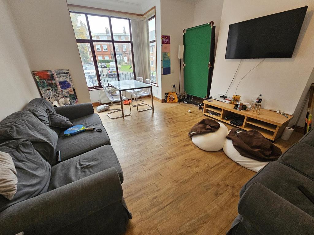 A spacious, well-lit modern living room featuri...