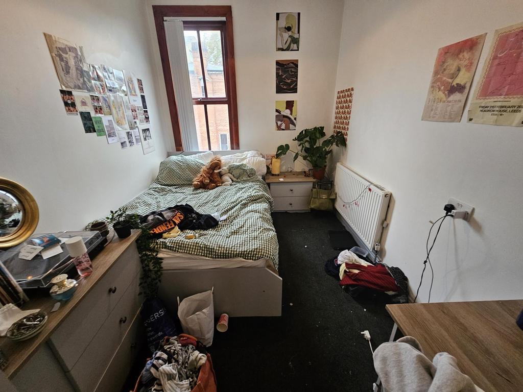 A cozy double bedroom featuring a large bed, a ...