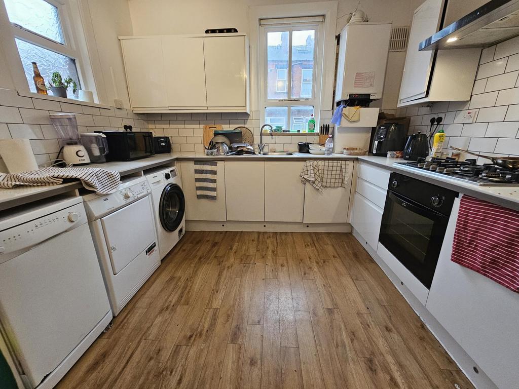 Bright, modern kitchen with plenty of storage a...