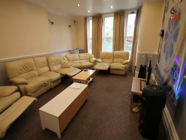 A spacious, well-lit living room featuring comf...