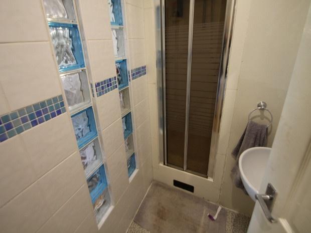A modern, clean bathroom featuring a large bath...
