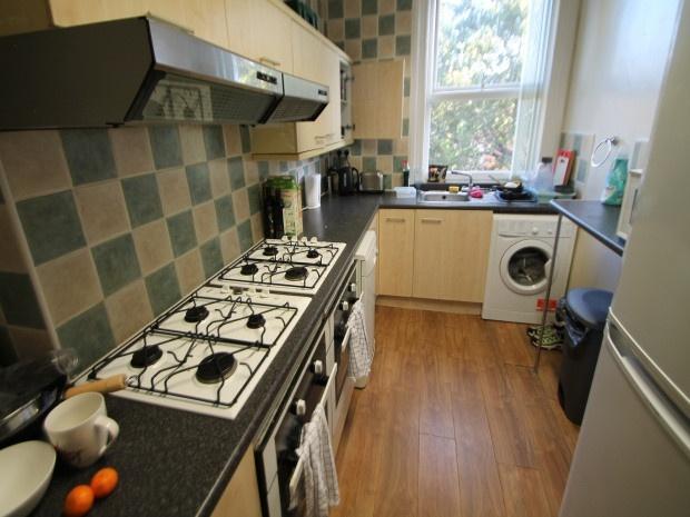 A functional and well-lit kitchen with a gas st...