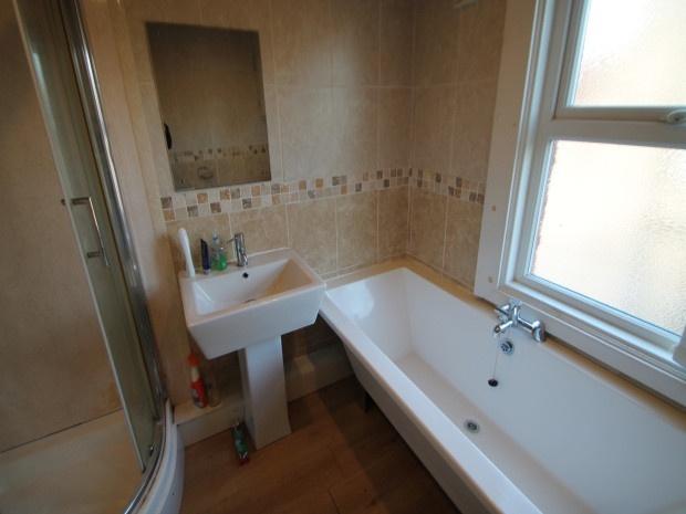 Bright and clean bathroom featuring a large bat...