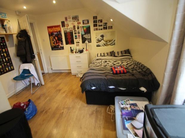 A cozy bedroom featuring a double bed with a be...