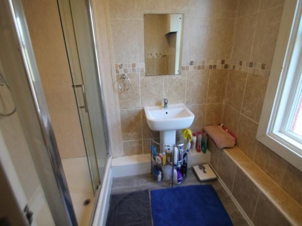A clean and bright bathroom featuring a shower,...