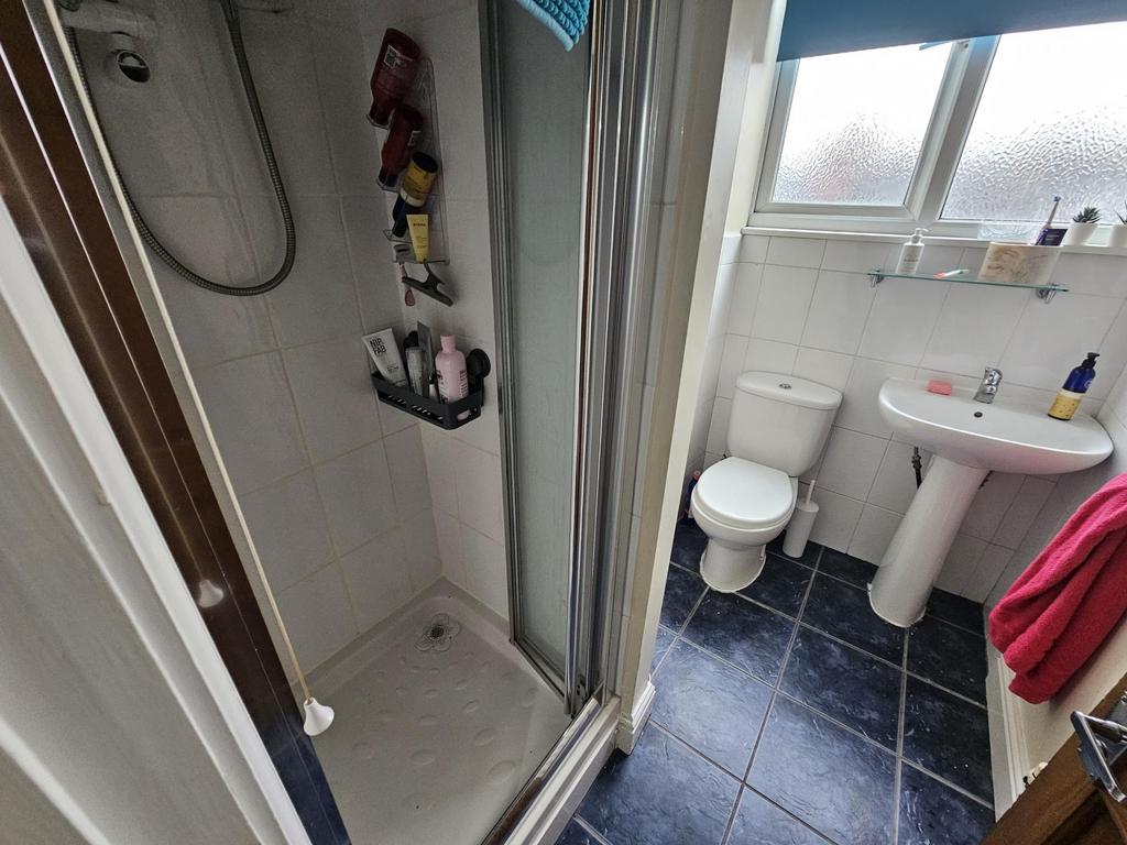 A bright and clean bathroom featuring a shower,...