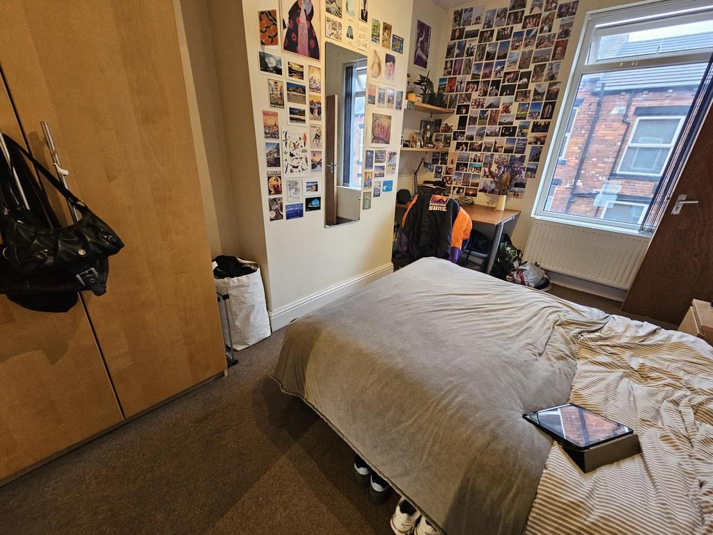 A cozy bedroom featuring a comfortable bed, dec...