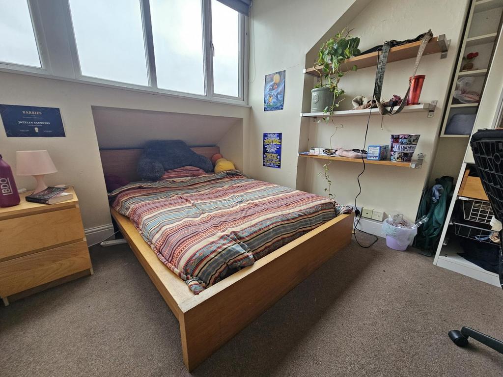 A well-lit, spacious master bedroom featuring a...