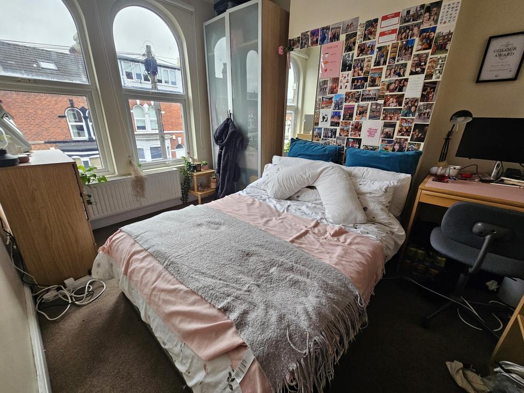 A spacious and inviting master bedroom featurin...