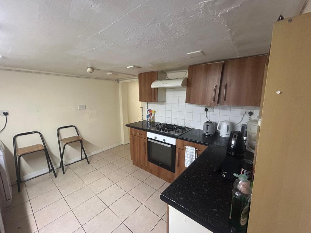 A well-maintained kitchen with modern wooden ca...