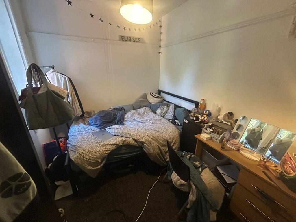 A cozy bedroom with a large bed, bedside tables...