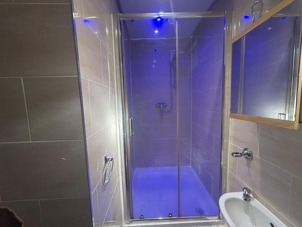 Modern and clean bathroom with a shower enclosu...