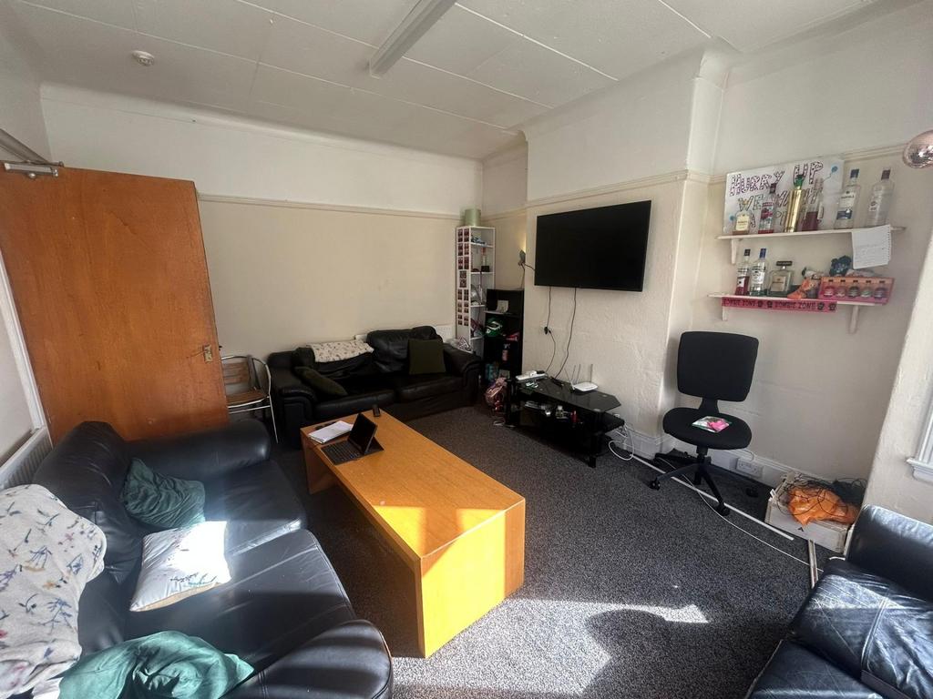 A spacious and modern living room featuring com...