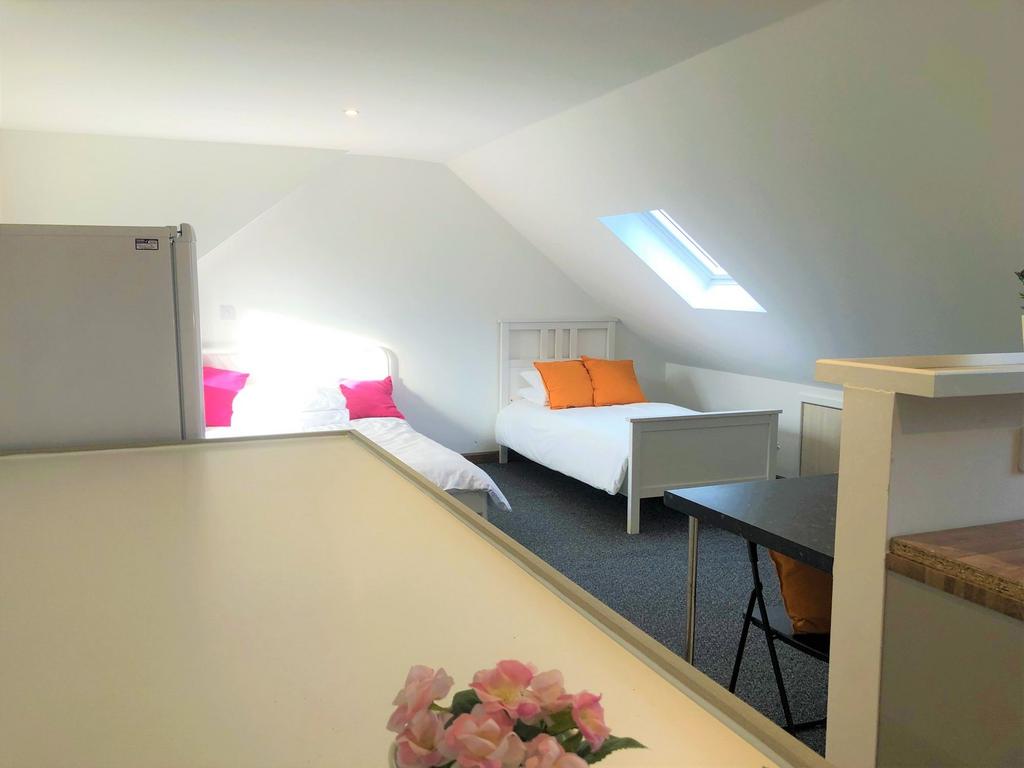 A bright and clean double bedroom featuring two...