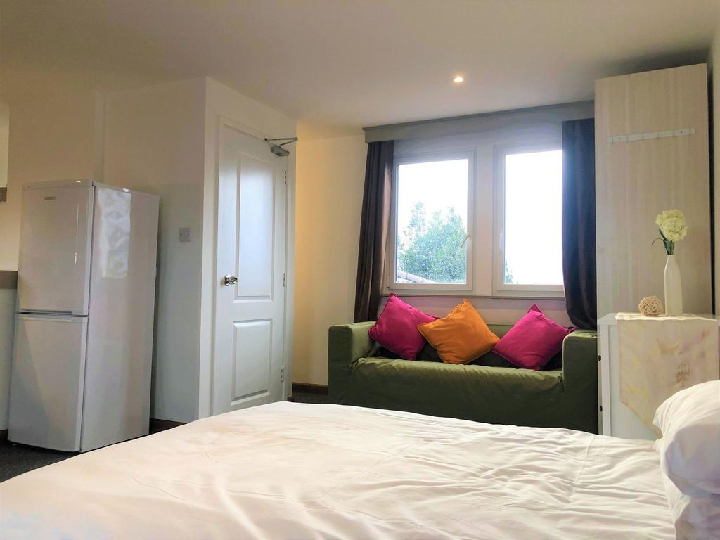 Bright and cozy double bedroom featuring a comf...