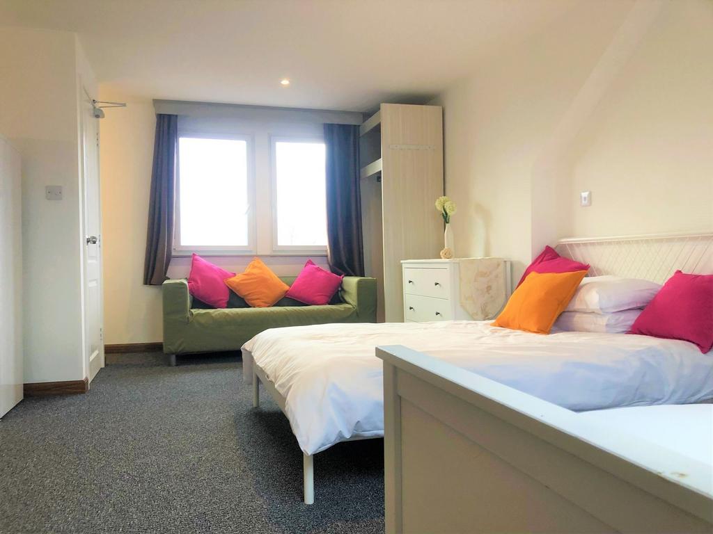 Bright and welcoming double bedroom featuring a...